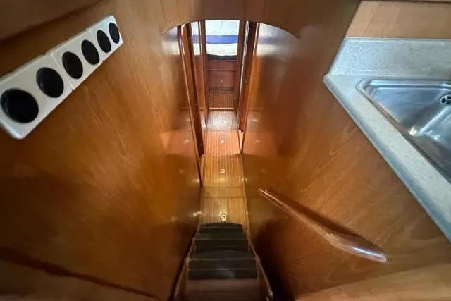 Slide: The Image of Wooden interior staircase on a 2001 Horizon 56 yacht, leading to lower cabin. - 27