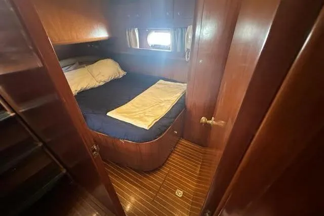 Slide: The Image of Cozy cabin interior of 2001 Horizon 56 yacht with wooden finish and bed. - 29