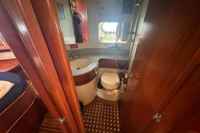 Slide: The Image of Bathroom interior of 2001 Horizon 56 yacht with wooden finishes and compact design. - 32