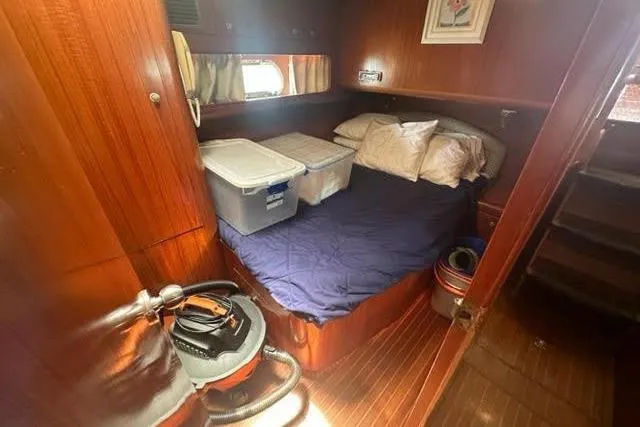 Slide: The Image of Cozy cabin interior of 2001 Horizon 56 yacht with bed and storage containers. - 33