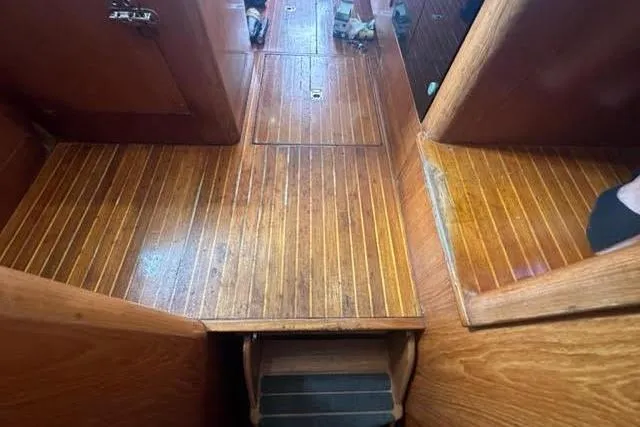 Slide: The Image of Wooden interior flooring of a 2001 Horizon 56 yacht, showcasing polished finish and steps. - 34