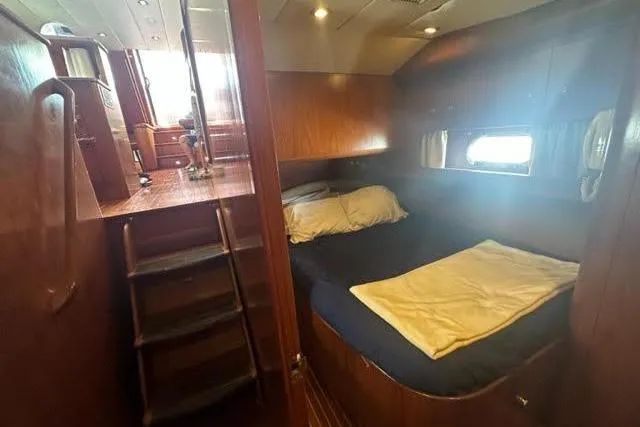 Slide: The Image of Cozy cabin interior of 2001 Horizon 56 yacht with wooden finish and bed. - 35