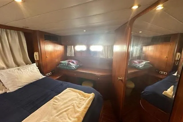 Slide: The Image of Luxurious cabin interior of 2001 Horizon 56 yacht with cozy bedding and wooden furnishings. - 41