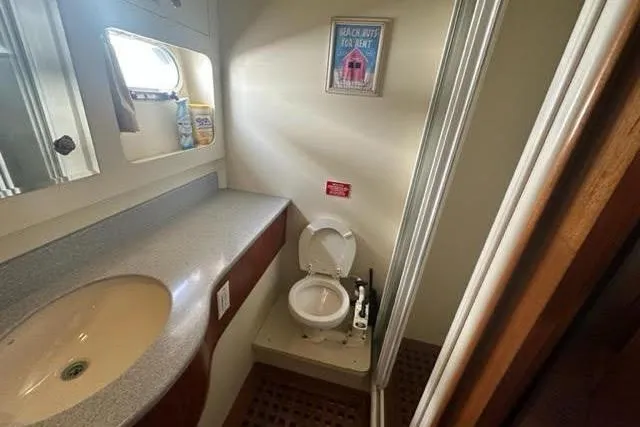 Slide: The Image of Bathroom interior of a 2001 Horizon 56 yacht with sink and toilet. - 42
