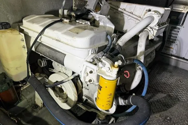 Slide: The Image of Engine compartment of a 2001 Horizon 56, featuring hoses and a yellow filter. - 44