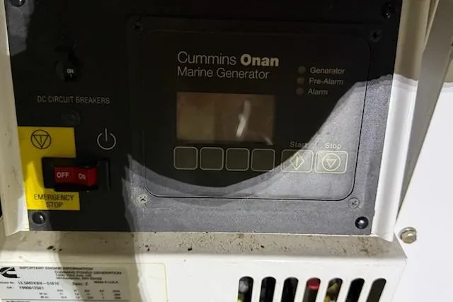 Slide: The Image of Control panel of a Cummins Onan marine generator on a 2001 Horizon 56 yacht. - 46