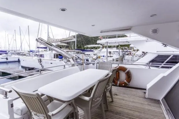 Slide: The Image of Luxury yacht deck with dining area, Horizon 56 model, 2001, docked at marina. - 6
