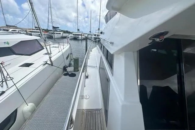 Slide: The Image of Docked Horizon 56 yacht from 2001, alongside other boats in a marina. - 8