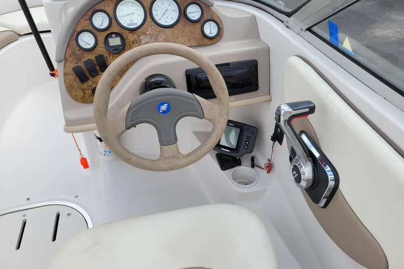 Slide: The Image of 1997 Four Winns 180 Horizon boat dashboard with steering wheel and control panel. - 10