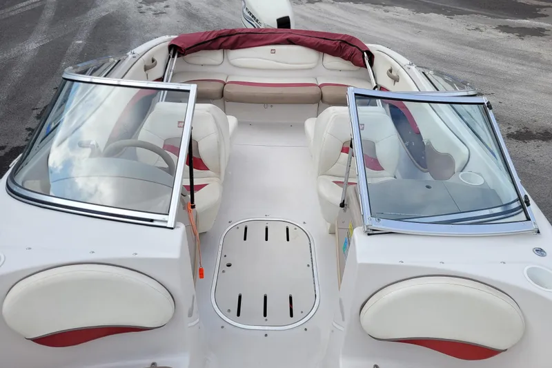 Slide: The Image of 1997 Four Winns 180 Horizon boat interior with white and red seating, open windshield. - 11