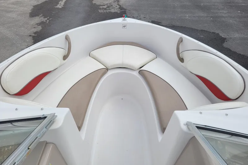 Slide: The Image of 1997 Four Winns 180 Horizon boat interior with white and beige seating. - 12