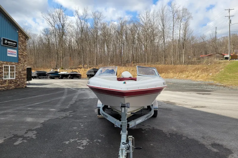 Slide: The Image of 1997 Four Winns 180 Horizon boat on trailer, parked outside dealership. - 4