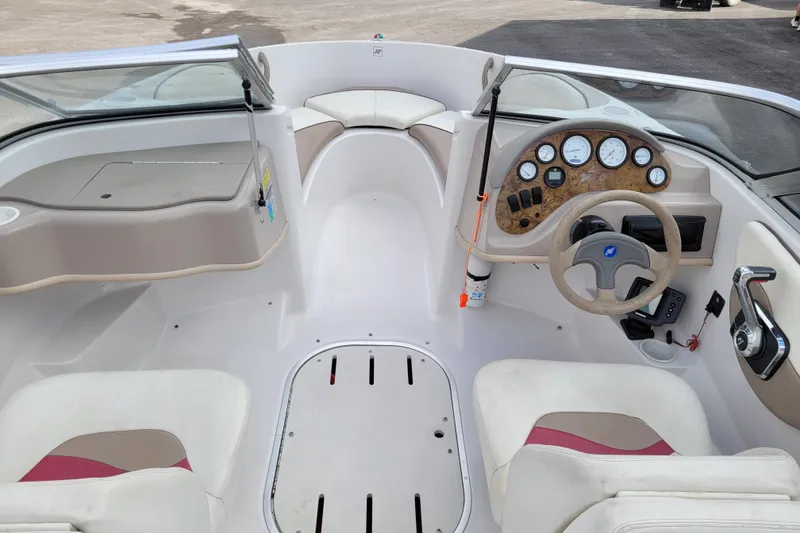 Slide: The Image of 1997 Four Winns 180 Horizon boat interior with steering wheel and dashboard controls. - 9