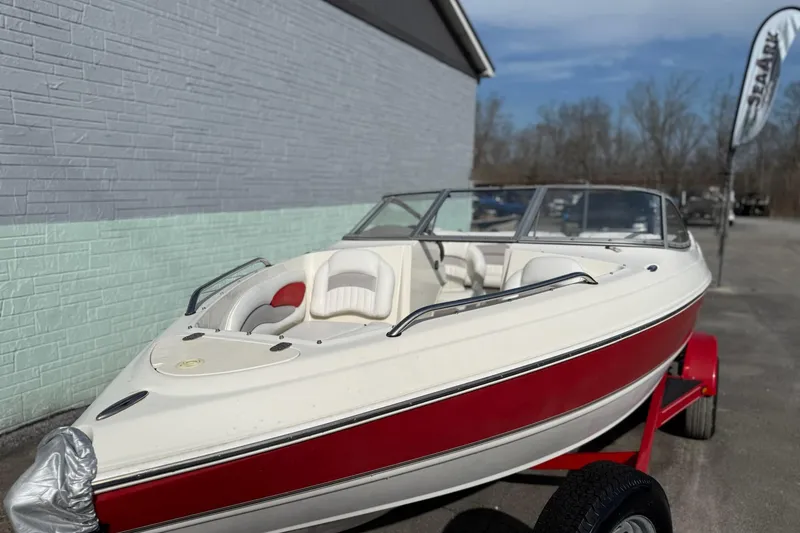 The Image of 2008 Stingray 205 LS/LX/LR boat with red and white design on a trailer. - 0