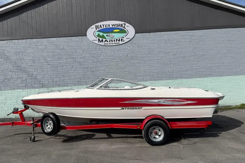 The Image of 2008 Stingray 205 LS/LX/LR boat on red trailer, parked outside Water Workz Marine. - 1