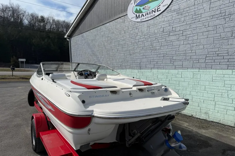 Slide: The Image of 2008 Stingray 205 LS/LX/LR boat on trailer outside marine shop. - 3