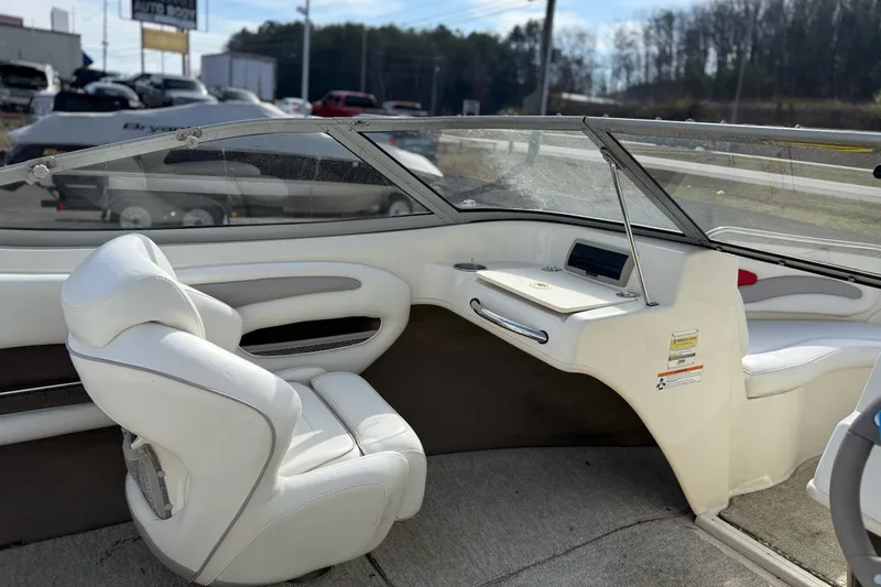 Slide: The Image of Interior of a 2008 Stingray 205 LS/LX/LR boat with white seating and dashboard. - 8