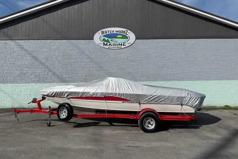 Slide: The Image of 2008 Stingray 205 LS/LX/LR boat covered on red trailer outside Water Workz Marine. - 9