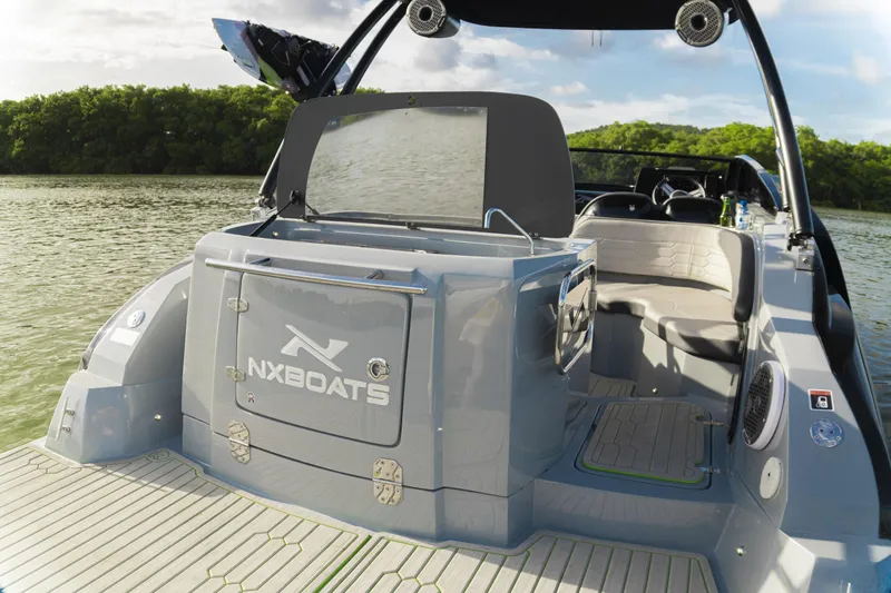 Slide: The Image of 2026 NX Boats NX260 on water, showcasing sleek design and modern features. - 11