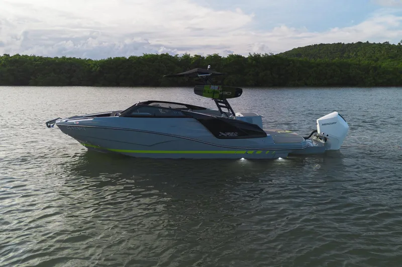 Slide: The Image of 2026 NX Boats NX260 on calm water, featuring sleek design and modern outboard motor. - 3