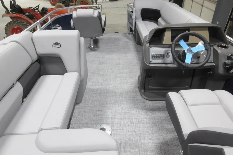 Slide: The Image of 2026 Sun Tracker SportFish 20 DLX interior with gray seating and steering console. - 4