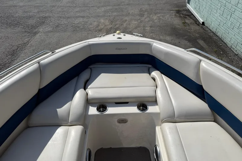 Slide: The Image of 1998 Bryant 214 Limited boat interior with white and blue seating, cup holders, and spacious layout. - 6