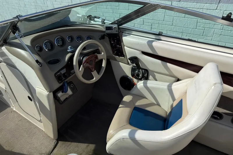 Slide: The Image of Interior of a 1998 Bryant 214 Limited boat with steering wheel and gauges. - 8