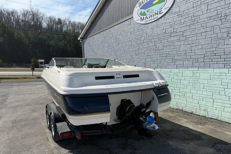 Slide: The Image of 1998 Bryant 214 Limited boat on trailer, parked outside marine service building. - 5
