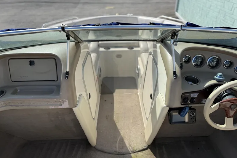 Slide: The Image of Interior view of a 1998 Bryant 214 Limited boat, featuring dashboard and seating area. - 7