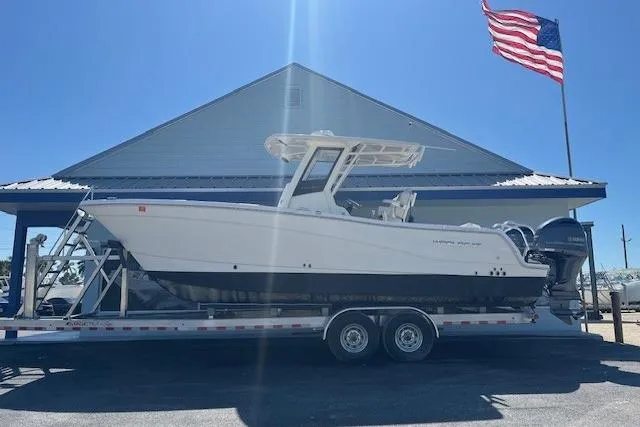 The Image of 2024 World Cat 260 CC-X boat on trailer, American flag in background. - 1
