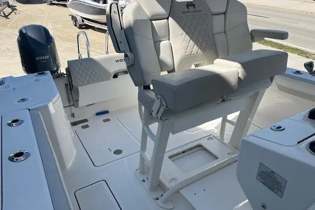 Slide: The Image of 2024 World Cat 260 CC-X boat interior with cushioned seating and dual outboard engines. - 6