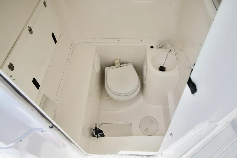 Slide: The Image of 2007 Fountain 34 Sportfish CC boat interior with white seating and steering wheel. - 13