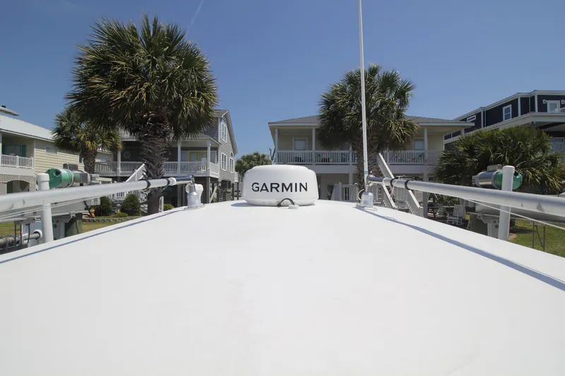 Slide: The Image of 2007 Fountain 34 Sportfish CC boat detail, featuring a white canopy and metal fixtures. - 20