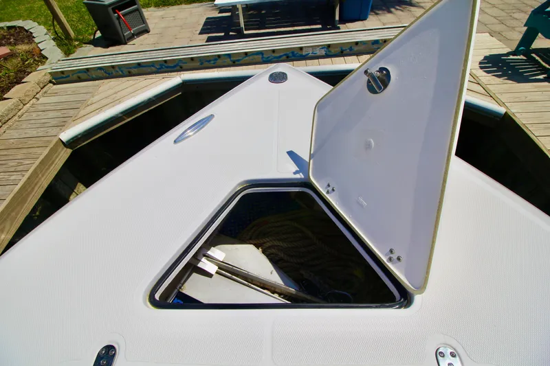 Slide: The Image of 2007 Fountain 34 Sportfish CC boat interior with rod holders and cushioned seating. - 23