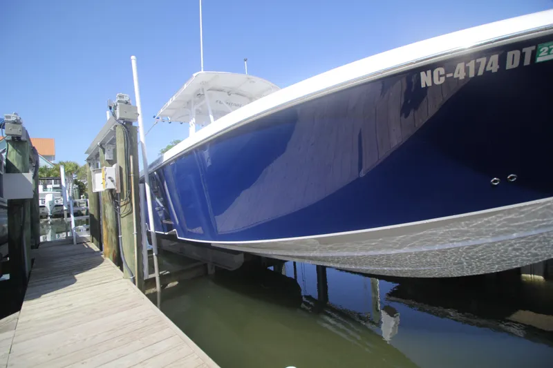 Slide: The Image of Outboard motors of a 2007 Fountain 34 Sportfish CC boat, covered and parked. - 34