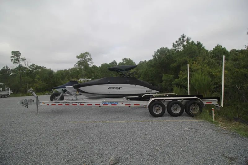 Slide: The Image of 2007 Fountain 34 Sportfish CC boat docked, featuring a sleek blue hull. - 36