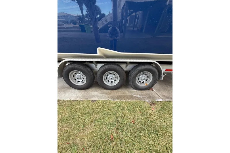 Slide: The Image of Boat trailer for 2007 Fountain 34 Sportfish CC beside a covered Yamaha 255X. - 39