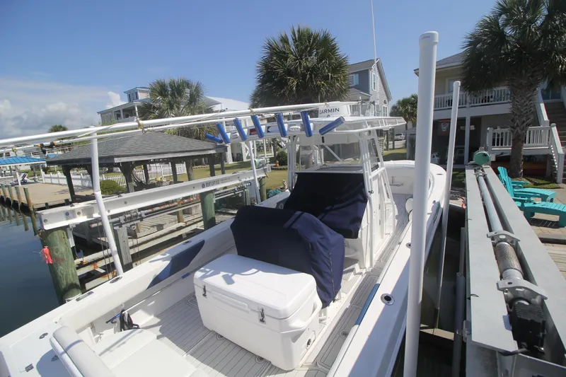 Slide: The Image of 2007 Fountain 34 Sportfish CC boat docked near waterfront homes. - 4