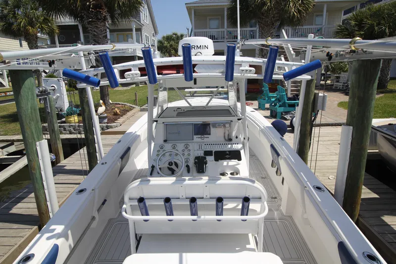 Slide: The Image of 2007 Fountain 34 Sportfish CC boat docked, featuring fishing rod holders and navigation equipment. - 6