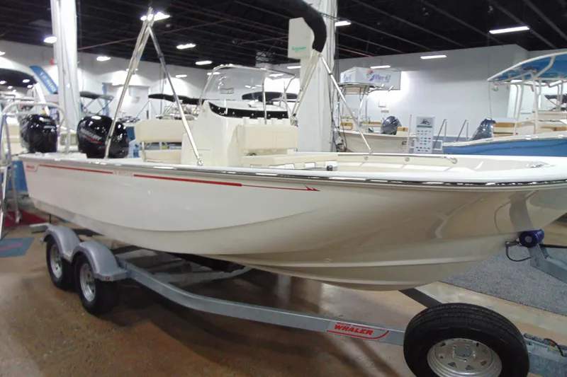 The Image of 2026 Boston Whaler 190 Montauk boat displayed on a trailer at an indoor showroom. - 0