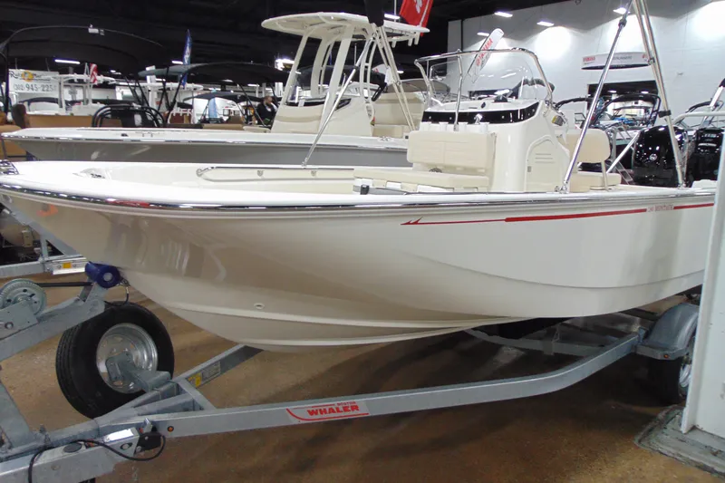 Slide: The Image of 2026 Boston Whaler 190 Montauk boat displayed on a trailer in a showroom. - 10