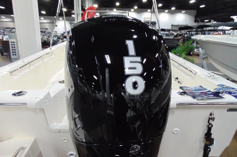 Slide: The Image of 2026 Boston Whaler 190 Montauk with 150 HP engine displayed indoors. - 3