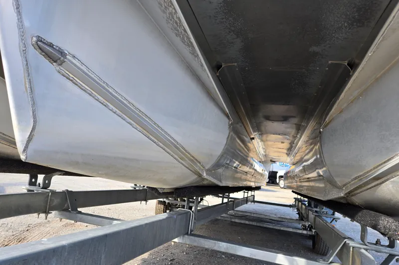 Slide: The Image of Underneath view of a 2020 Avalon LSZ VRB 24' pontoon boat on a trailer. - 11