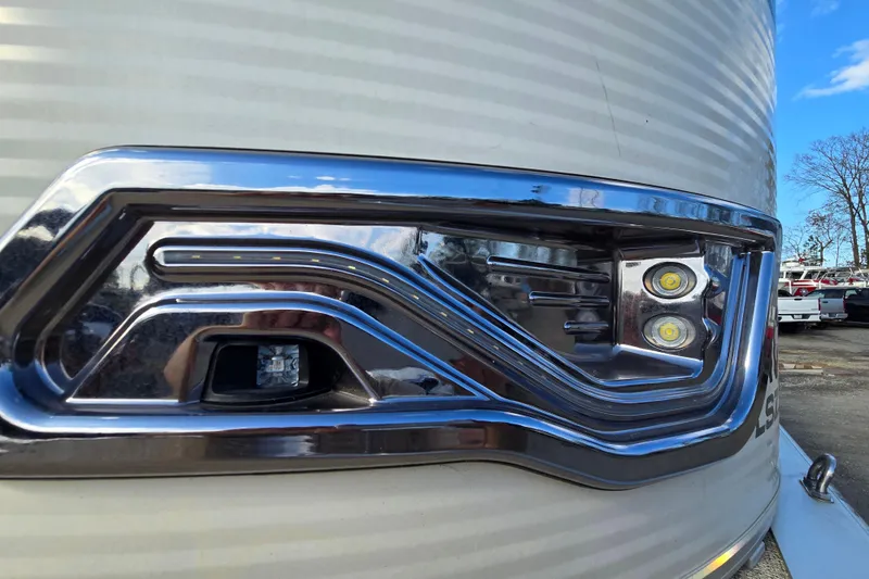 Slide: The Image of Close-up of 2020 Avalon LSZ VRB - 24' boat's sleek chrome headlight design. - 14