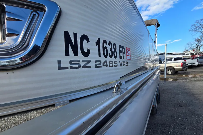 Slide: The Image of 2020 Avalon LSZ VRB 24' boat with registration NC 1638 EP in a parking lot. - 15