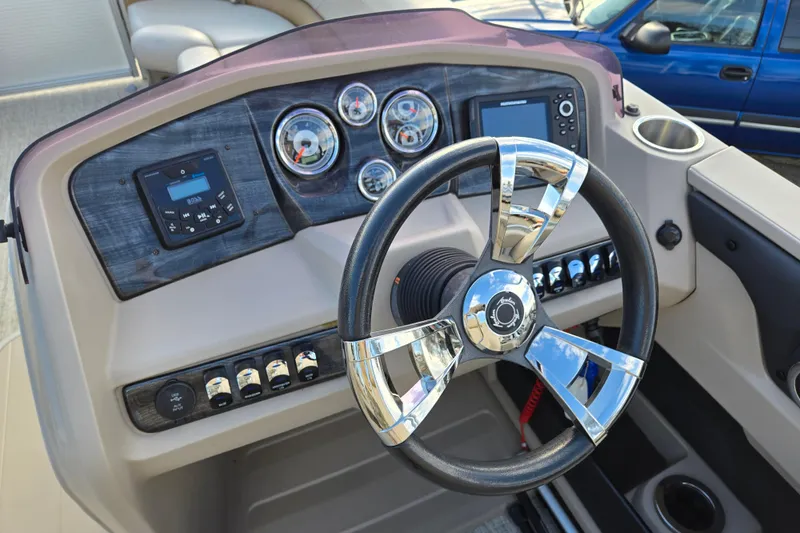 Slide: The Image of 2020 Avalon LSZ VRB 24' boat dashboard with steering wheel and control panel. - 19
