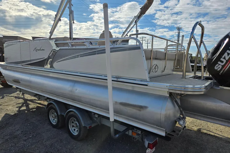 Slide: The Image of 2020 Avalon LSZ VRB 24' pontoon boat on trailer, featuring Suzuki outboard motor. - 2