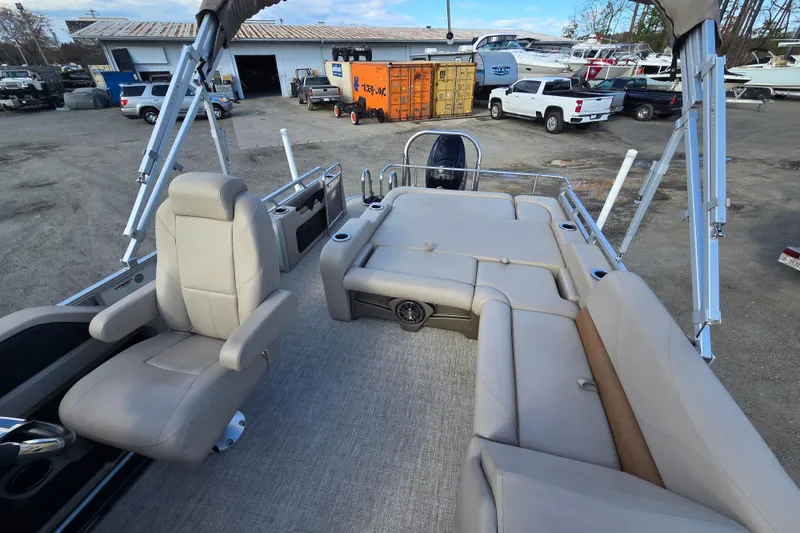 Slide: The Image of 2020 Avalon LSZ VRB 24' pontoon boat interior with beige seating and helm chair. - 20