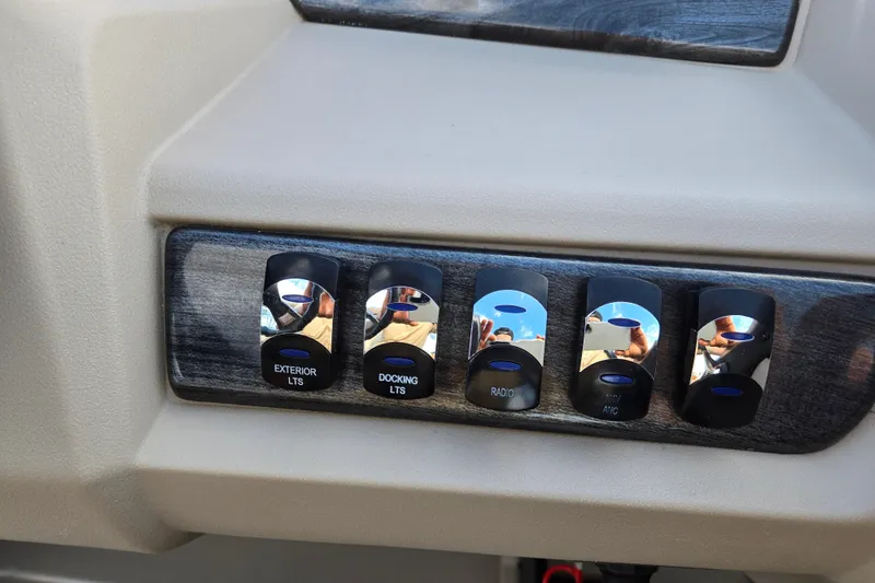 Slide: The Image of Control panel of a 2020 Avalon LSZ VRB - 24' boat with labeled switches. - 27