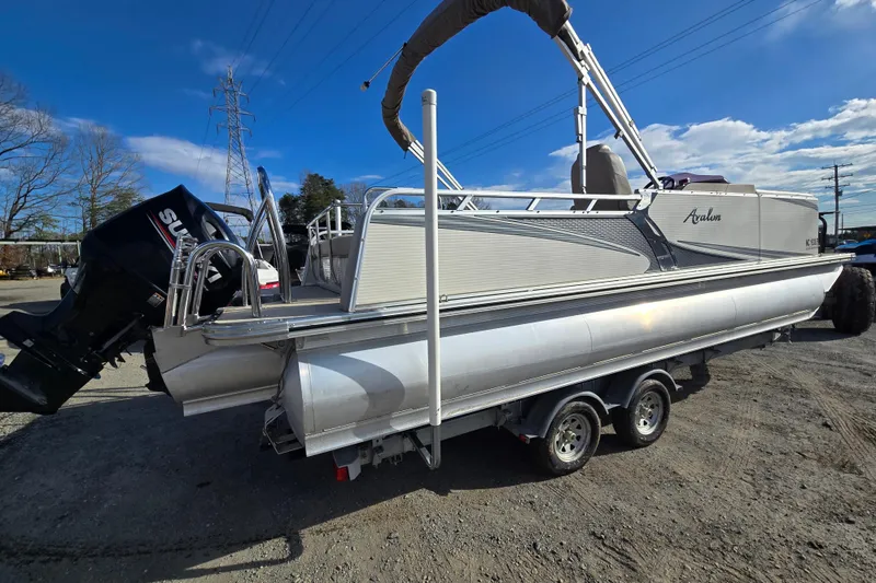 Slide: The Image of 2020 Avalon LSZ VRB 24' pontoon boat on trailer, featuring Suzuki outboard motor. - 3